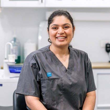 Female dentist in grey top