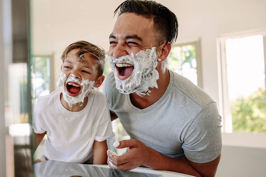Father and son playing with shaving cream