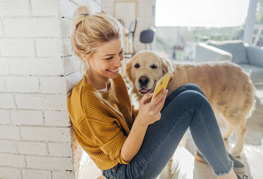 Girl with her dog texting